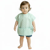 Plie short sleeve waterproof bib in baby blue dots protects clothing during meals.