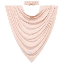 Posh Peanut Sandy Blush newborn in swaddle demonstrating snug, secure wrap.