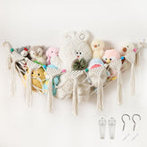 Pretty Jolly moon-shaped hammock wall pocket in cream keeps toys organized.
