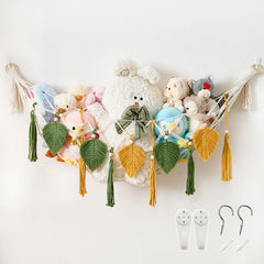 Pretty Jolly moon-shaped hammock holds plush toys in a nursery for organized storage.