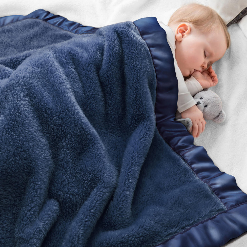 Pro Goleem fleece blanket in navy with satin trim for cozy crib time
