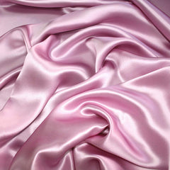 Pro Goleem pink satin nursing cover on pillow, showcases zipper protection for baby's skin safety.