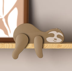 PUTSKA wooden sloth decor enhances nursery shelves with woodland charm.