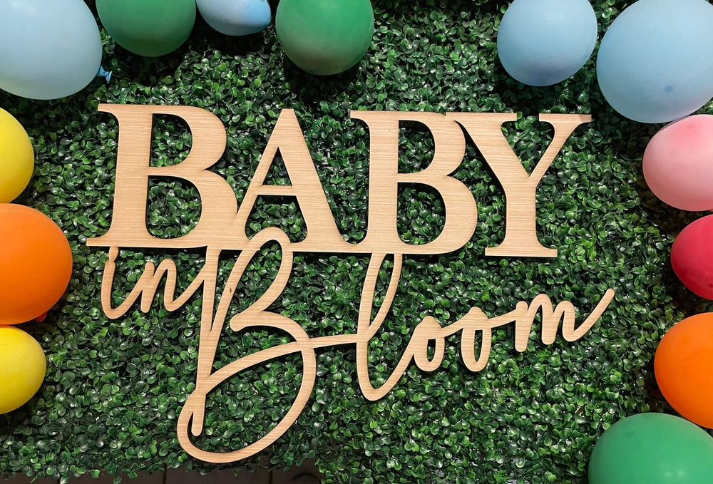 QENWWENG wooden Baby In Bloom sign adds rustic charm to a 16x12 centerpiece for baby showers.