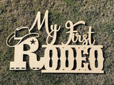 QPARTYFIRE My First Rodeo Sign front view, warm wooden backdrop ideal for photos.