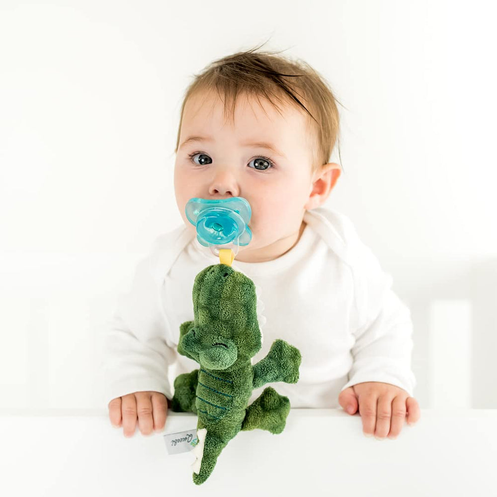 Queebi PaciBuddy crocodile plush keeps pacifier within reach for soothing snuggles.
