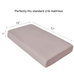 QUENESS muslin crib sheet on crib mattress demonstrates secure, fitted design.
