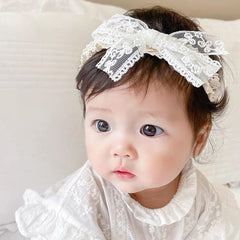 Close-up of Rannyrena lace headband highlighting soft stretch fabric for gentle wear.