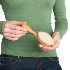 Redecker baby hairbrush full-length shot emphasizing soft bristles' gentle touch.