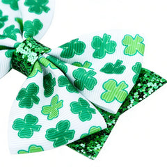 Roffiy glittery four-leaf clover bow clip flat lay for festive styling.