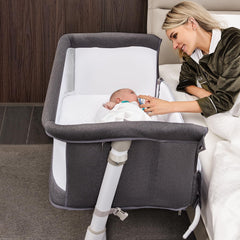 RONBEI Baby Bassinet beside bed closeup—soft fabric for gentle nighttime proximity and easy access.