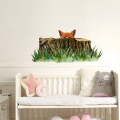 RoyoLam fox behind stump wall decal in a sunny nursery
