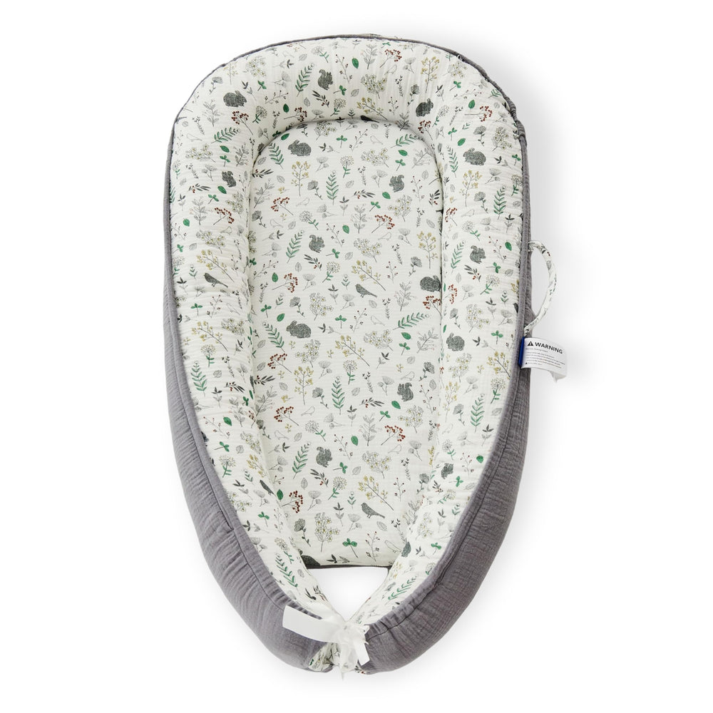 RYXTHALA premium muslin baby lounger folded for travel convenience.