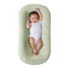 Saanerueen baby lounger in green cover provides cozy newborn support at home.