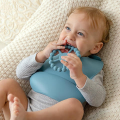 Soft, flexible silicone teether fits tiny hands for easy grip.