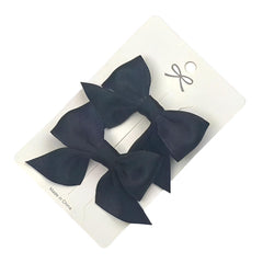 SEVENHEAD bow hair clip black back view showing snag free metal clip