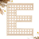She Love wooden rattan E wall decor for boho nursery signage and personalization.