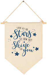 Sioial Look At The Stars banner hanging above crib for cozy nursery decor.