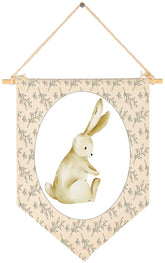 Sioial nursery rabbit-theme banner hanging above crib adds playful decor.