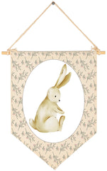 Sioial nursery rabbit-theme banner hanging above crib adds playful decor.