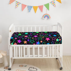 Smell Sunshine crib skirt coordinates with colorful gradient stars for a cohesive look.