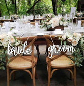 Snlioek bride and groom chair sign in rustic style enhances wedding ambiance.