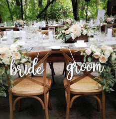 Snlioek bride and groom chair sign in rustic style enhances wedding ambiance.