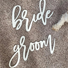 Snlioek wooden wedding sign for bride and groom on reception display.