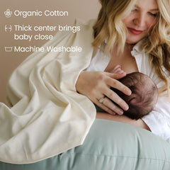 Snuggle Me Organic pillow used during baby feeding on a couch