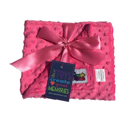 Snuggle Stuffs reversible minky dot blanket in hot pink provides warm crib comfort.