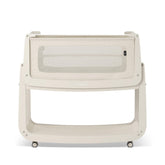 SnuzPod 5 bedside bassinet shown beside a bed for convenient nighttime proximity.
