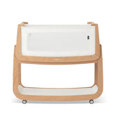 SnuzPod 5 bedside bassinet with breathable windows for visibility and airflow.
