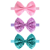 Song Qing sequined bow hair band for infant girls with soft cotton comfort.