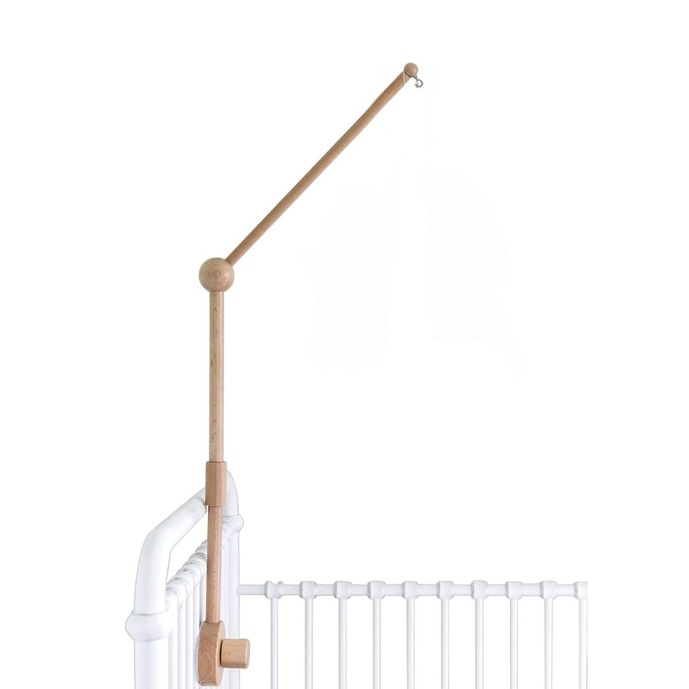 Sorrel + Fern baby crib mobile arm in natural beechwood securely holds a mobile.