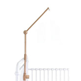 Sorrel + Fern baby crib mobile arm in natural beechwood securely holds a mobile.