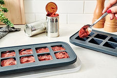 Top view of charcoal Souper Cubes molds for herbs and garlic.