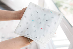 Spilt Milk five-pack cotton muslin washcloths shown together for gentle mess cleanup.
