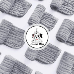 Spotted Play grey muslin burp cloth with reinforced edges and high absorbency.