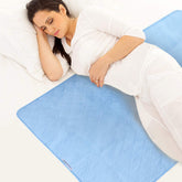 SPRINGSPIRIT bed pads unfolded on bed protecting sheets from spills and dampness.