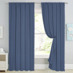 StangH pom-pom trim close-up on stone blue curtains.