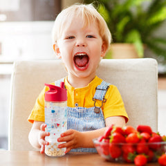 Stephen Joseph Space snack cup attached to bottle for convenient travel snacks.