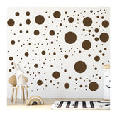 StickerDeen brown polka dot circle wall sticker on a nursery wall for playful decor.