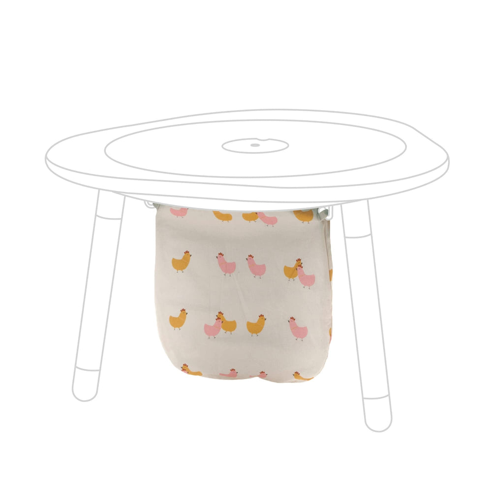 Stokke MuTable Cotton Bag with Chicks pattern attached to hooks for tidy toy storage.