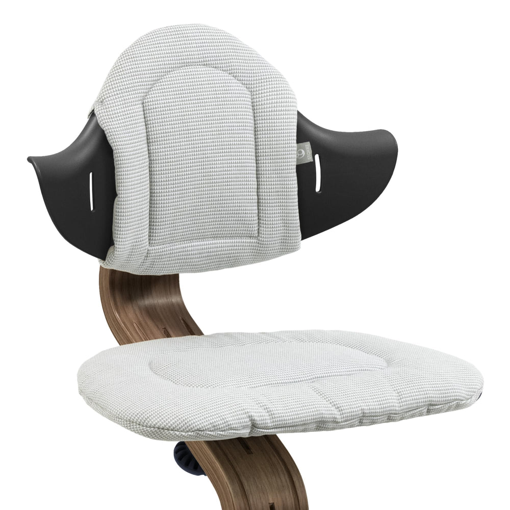 Stokke Nomi cushion in Nordic Grey Sand attached to chair for added softness