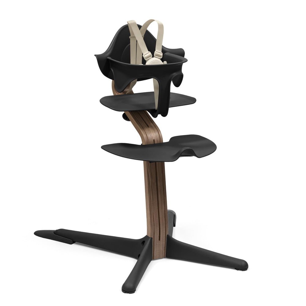 Stokke Nomi high chair front view in black and walnut showing family table seating