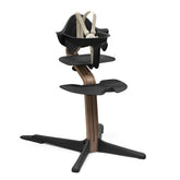 Stokke Nomi high chair front view in black and walnut showing family table seating