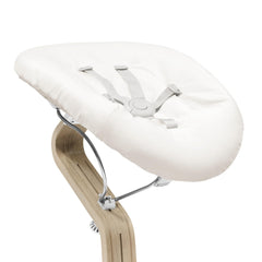 Stokke Nomi newborn set harness provides secure seating for early bonding.