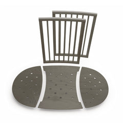 Stokke Sleepi Bed Extension V2 in hazy grey packaging shows included parts for quick setup.
