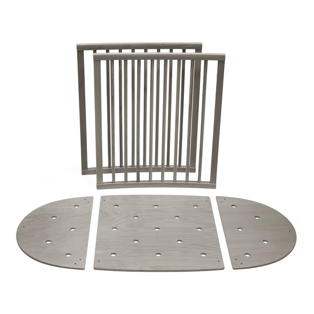 Stokke Sleepi Bed Extension V3 hazy grey shows simple assembly for nursery flexibility.