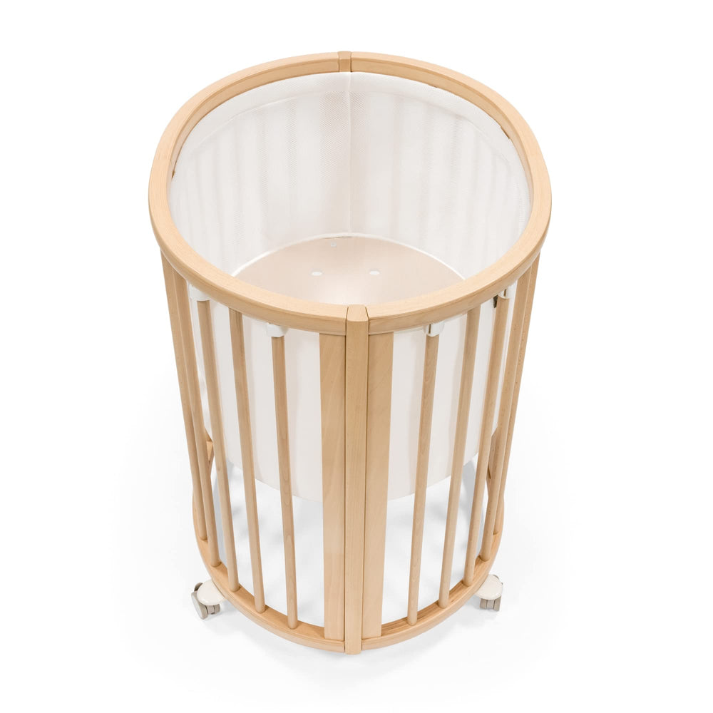 Stokke Sleepi Mini Mesh Liner V3 white closeup showing breathable fabric for safe sleep.